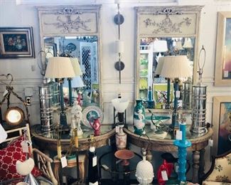 Pair of painted trumeaus, pair of silvergilt demilune consoles with mirrored tops.