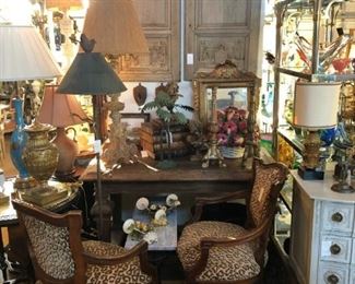 Pair of 19th century walnut fauteuils in leopard, 19th century walnut table, pair of carved fragment panels.