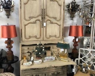 Painted seretaire, pair of bronze floral sconces, pair of finial form table lamps, bouillotte lamp with oval tole shade, painted 19th century armchair with pieced back.