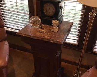 One of two walnut with marble top pedistals
