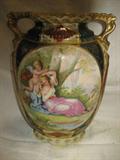 AUSTRIAN PILLOW VASE, 9 INCHES TALL WITH A CHERUB AND SEMI NUDE WOMAN