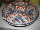PORCELAIN CONDIMENT TRAY ON A LAZY SUSAN ABOUT 15 INCHES IN DIAMETER