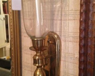 One of two brass wall sconces
