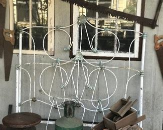 Cast iron bed, crosscut saw,, lanterns, piano stool, wheel barrows