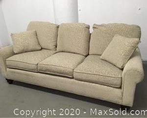 Clean sofa with two matching throw pillows