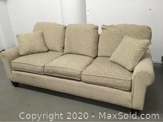 Clean sofa with two matching throw pillows