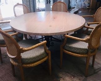 designer round  dining table  with six chairs--Table has a wrought iron pedestal  bottom