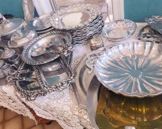 large collection of pewter style serving pieces