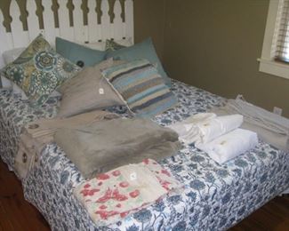 Queen bed with picket headboard and more linens