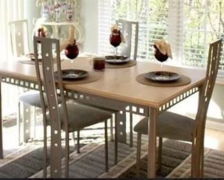 Nook set consist of light wood top & metal.  Four chairs in metal & light celery colored fabric on seat