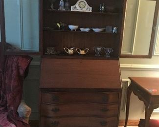 Mahogany secretary w/pull down ledge for displaying glassware. Curved front adds to the beauty of this piece