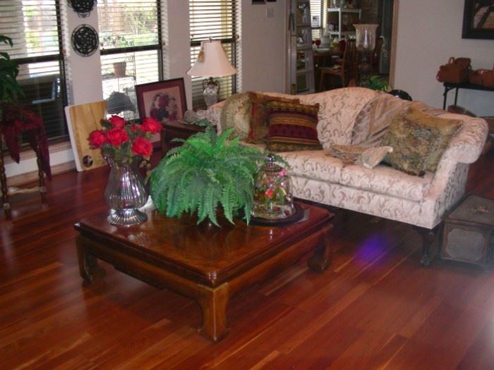 Camelback sofa with Oriental-style coffee table and matching side table.