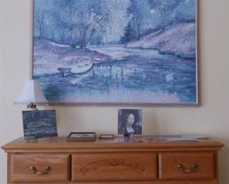 Large and small wall art and chest of drawers.