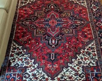 Vintage handwoven Persian Heriz wool rug, measures 10' x 7'.