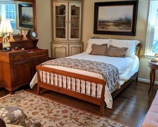 Full size cherry bed, with Sferra linens, matching cherry dry sink and wall mirror, handwoven flat-weave Persian Tabriz design rug and vintage 2-piece French country corner cabinet, with wire mesh doors.