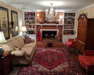 Den full of goodies!                                                               Beautiful hand woven Persian Heriz, measuring 7' x 10', pristine down-filled sofa, by Milling Road (the upholstery division of Baker Furn. Co.) pair of vintage mahogany 3-drawer chests, pair of upholstered French bergere chairs, 1940's bird's eye maple high boy, by White Furn. Co., Mebane, NC, pair of nicely framed/matted, hand painted Chinese Ancestors, three pairs of Asian cloisonne vases/urns, antique English brass fire fender, pair of fabby marble table lamps, pair of brass flower andirons, two bookshelves crammed with vintage books and travel souvenirs, all lit by a 6-light cut crystal chandelier. 