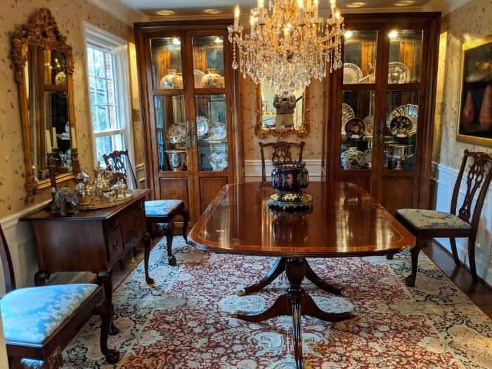 Beautifully appointed dining room, with Henkel-Harris banded mahogany table (includes 2 leaves, with original storage sleeves, pads and boxes, set/6 Hickory Chair Chippendale style hand carved mahogany side chairs, nicely framed "Three Pears" Encaustic, by Maggie Hasbrouck, 1994, hand woven Persian Kashan rug, 12' 2" x 8' 11", Chippendale style low boy chest, by Century Furn. Co., from their Henry Ford Museum Collection, pair of Century Furn. Co. lighted/beveled glass china cabinets, pair of gilt wood mirrors and gorgeous 13-light cut crystal Maria Theresa chandelier. 