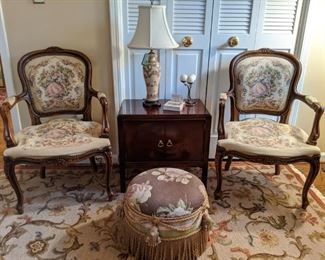 Pair of French bergere chairs, with tapestry fabric, vintage mahogany 2-door chest, Asian porcelain table lamp, w/shade & finial and custom made ottoman, with French braid and metal bees.