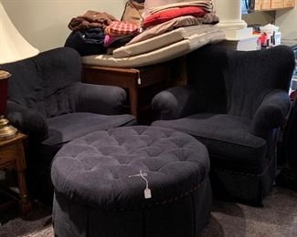 Dark blue lounge chairs and ottoman. 