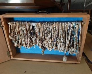 Approximately 114 necklaces in vendors case