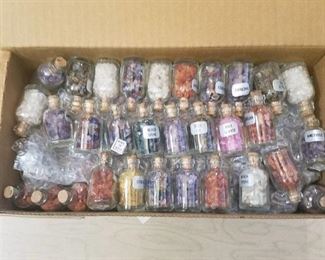well over 100 small bottles of assorted gemstones