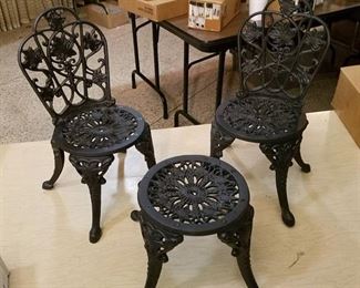 4 cast iron doll chairs and 2 cast-iron doll tables- all unassembled, new in box