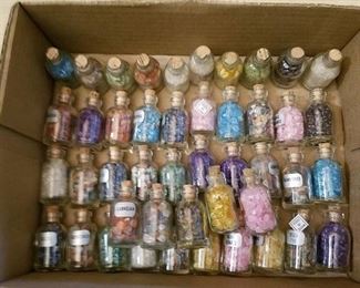 approximately 45 small bottles of assorted gems
