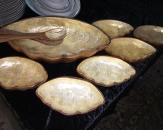 Unique vintage salad set. It’s carved wood with mother of pearl surfaces. 