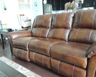 Leather sofa with recliners on each end.