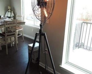 This is a floor lamp designed to look like a floor fan. It has  a very substantial tripod base. Very cool!
