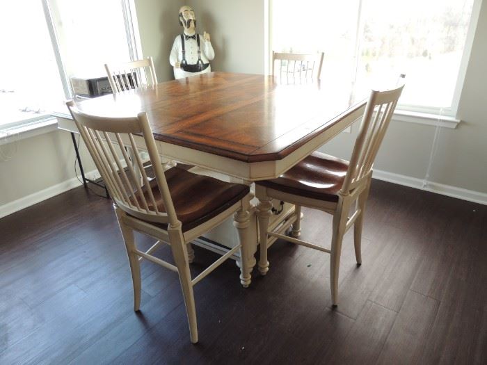 Counter high at 30". Table has 14" removeable leaf that can expand the size from 54" x 40" to 54" X 54". has 4 chairs and will seat 8.  Built in drawers in base 