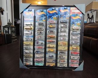 50 Hot Wheels mounted in a custom frame for display. Found in a dusty estate sale  and not touched.  Dust included!