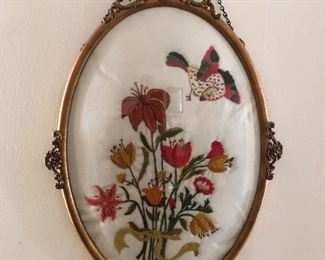 Antique brass oval needle point art.