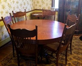 Solid oak round pedestal table and 6 Cain & Spindle chairs with decorative ... 