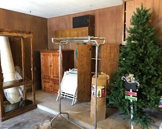 garage is full of furniture pieces, some tools, some Christmas