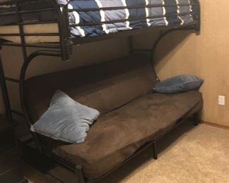 Metal twin over full futon bund bed with built in side ladders, bedding included.  Futon has mattress topper with suede cover 