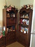 Matching shelving units with cabinet or drawers below, one has a hidden storage area.