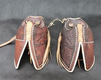 Leather Tapadero Stirrups. Tooled-leather with white lacing. https://ctbids.com/#!/description/share/314370