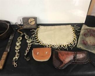 Leather pouch with decorative beads, call whips, leather cutting tool, holster, pouch, call whips and metal shank.  https://ctbids.com/#!/description/share/314551