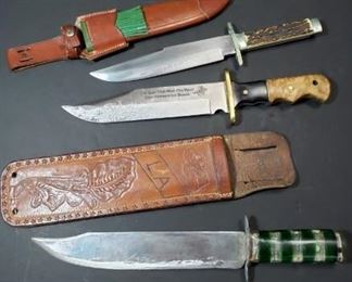 Three Bowie Knife Sets. First knife measures 12 1/2 inches total with an 8 inch blade, second knife measures 14 inches total with an 8 1/2 inch blade and third knife measures 14 1/2 inches with a 10 inch blade. https://ctbids.com/?site=1#!/description/share/314477