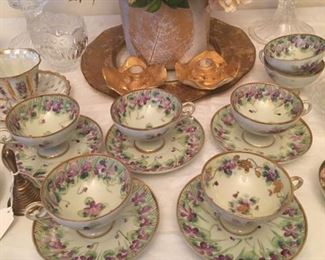 Beautiful porcelain china tea cups and saucers. 7 cups; 5 saucers. No mark.