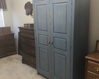 wood armoire /cabinet  lots of storage here 