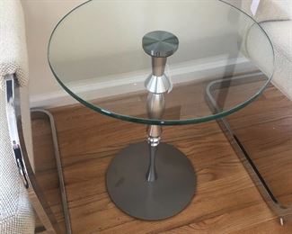 Modern chrome base attached to nice glass top. A great mid century modern look.