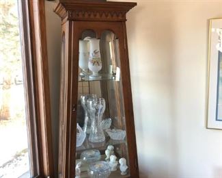 Corner curio cabinet filled with crystal
