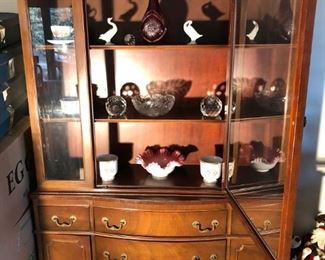 Dining room hutch filled with antiques 