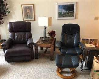 Two leather chairs; one recliner and  one with ottoman