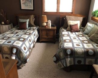 Two matching single beds like new with end table and pillows, bedding