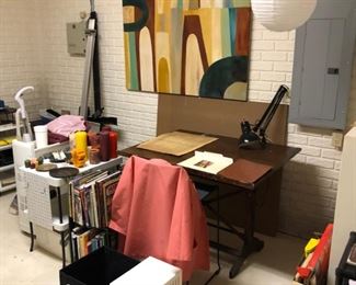 Two artist tables filled with easels, art supplies and every imaginable art items