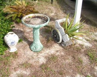 birdbath and concrete cart planter