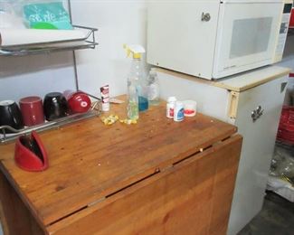Drop leaf table, small microwave and refrigerator.